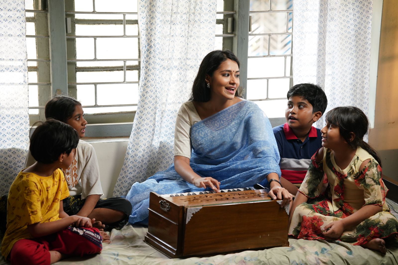 A tutor teaching children at home